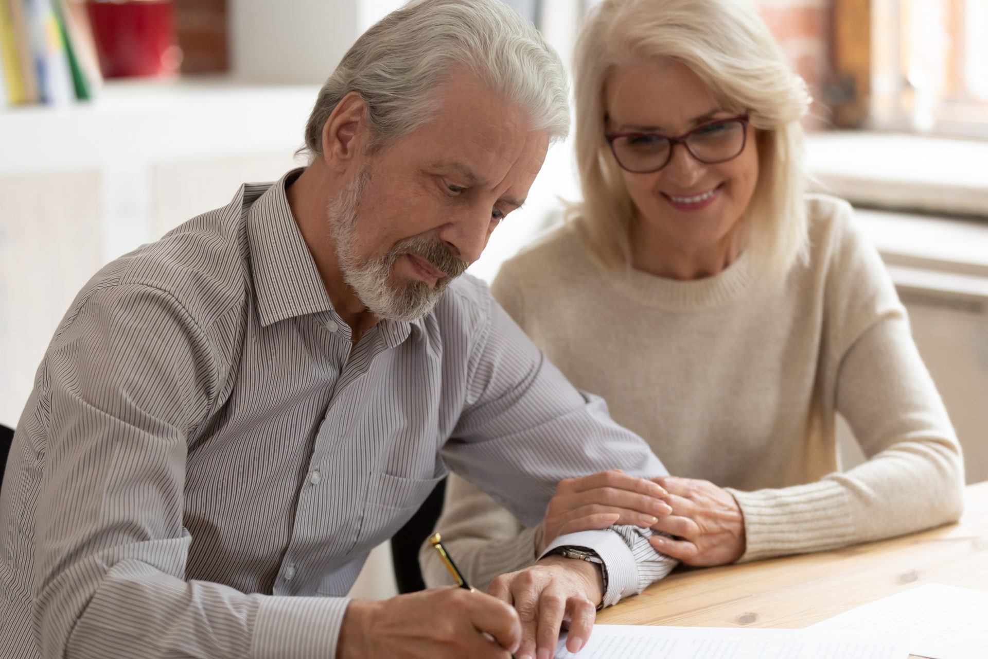 an older couple writing a will together